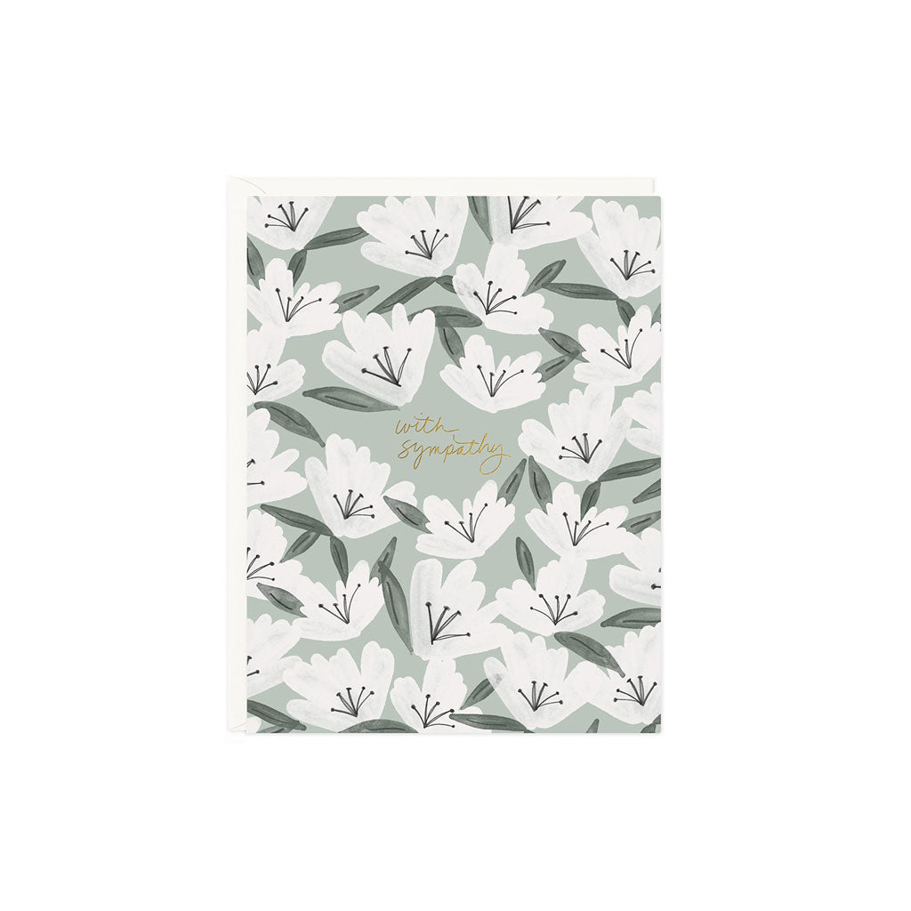 Card with floral design on front and text that reads with sympathy