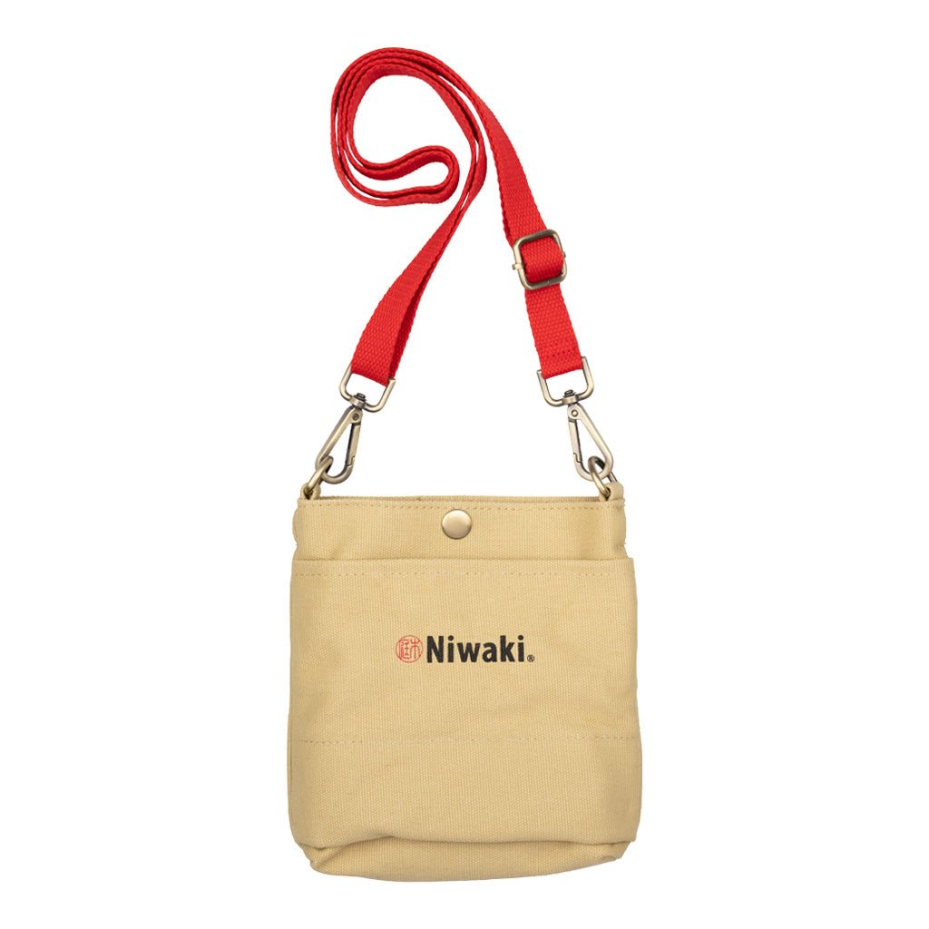 Beige canvas garden pouch with red strap and Niwaki branding on white background
