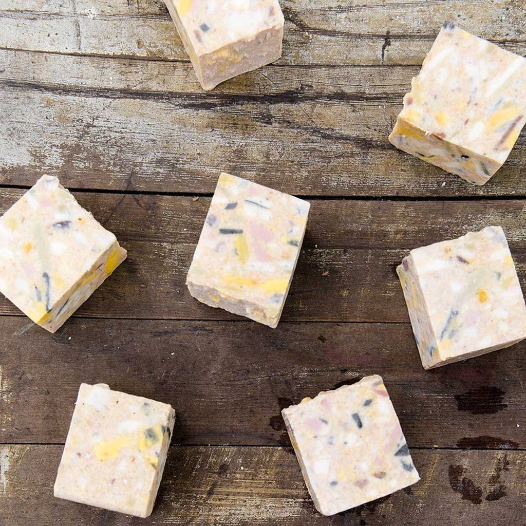 Bars of SallyeAnder stain removing Gardener's Hand Soap on wooden table