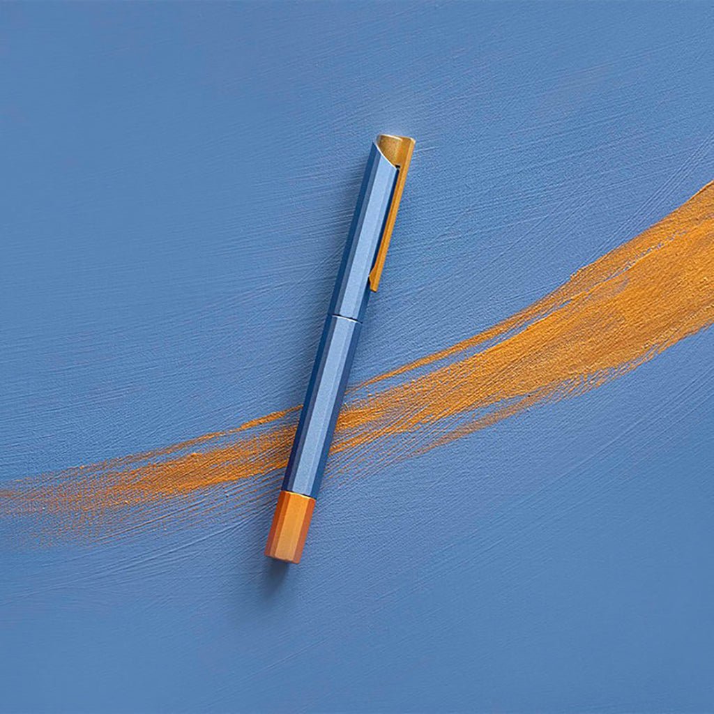 Pen with gold accents on a blue background
