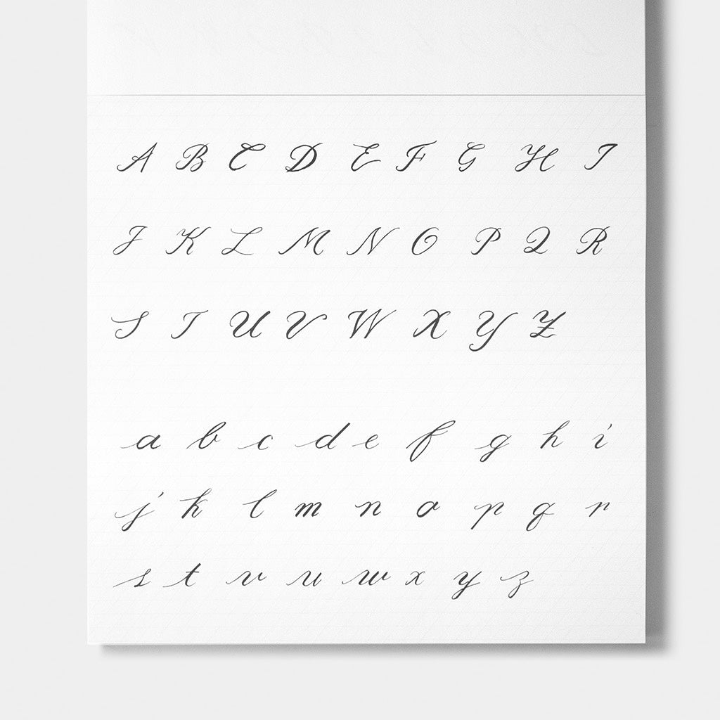 A white alphabet sheet showing uppercase and lowercase cursive script letters from A to Z in dark gray, photographed against a light gray background.