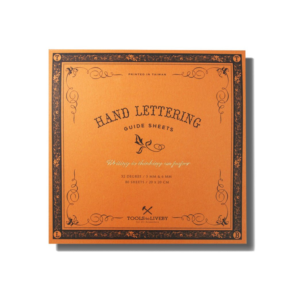 An orange Hand Lettering Guide Sheets pad on white background