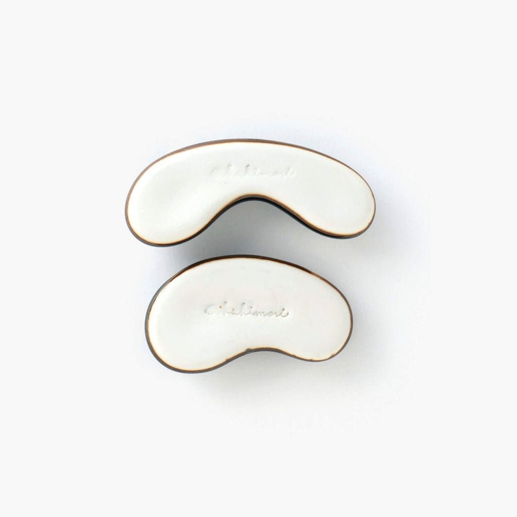 Bottom of Hasami pen rests showing Kakimori inscription underneath against white surface