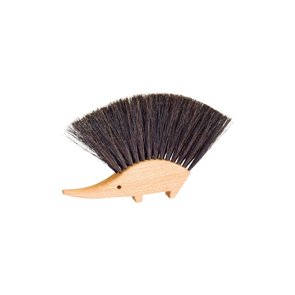 A hedgehog-shaped bristle brush with a light natural wood body and dark brown to black bristles, shown on a plain white background.