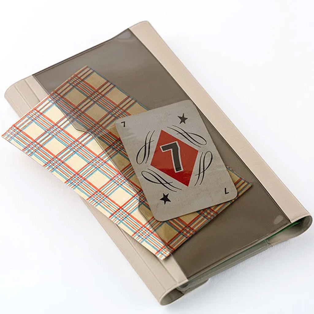 Light warm gray alettone case with front pocket and stationery accessories for Hobonichi Techo Weeks on white background
