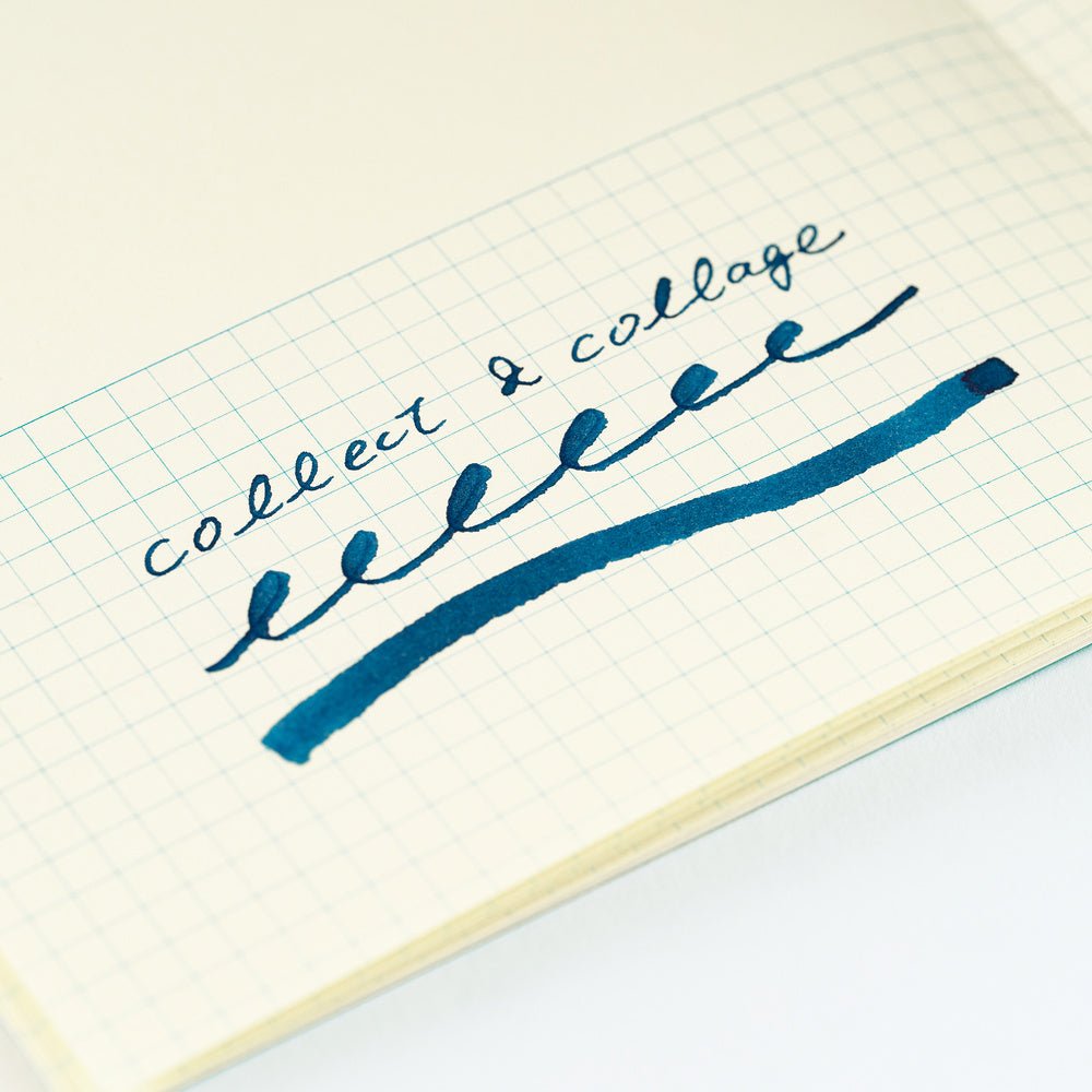 A close-up of a hand-written note on graph paper, showing the cursive text 'collect & collage' written in dark blue ink with a matching underline.