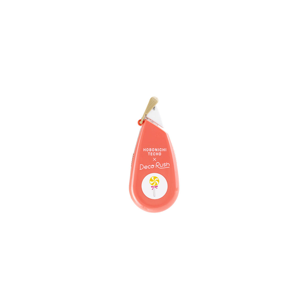 Coral pink Deco Rush tape dispenser by Hobonichi with candy designs on white background