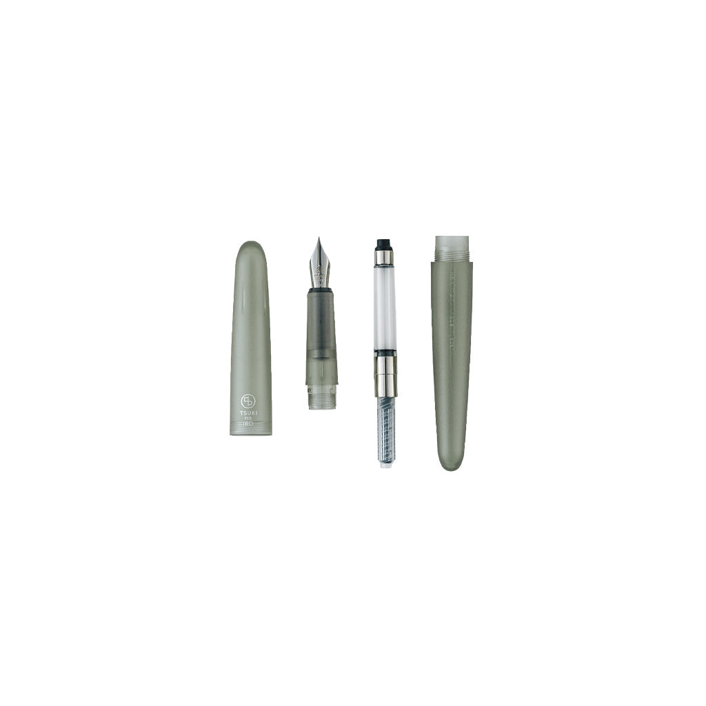 A disassembled fountain pen shown on a clean white background, with the cap removed and placed beside the nib, filler tube, and barrel.