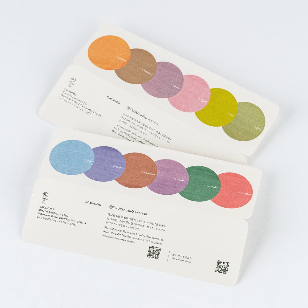 Two printed cards with circular color swatches and Japanese text, photographed on a clean white background.