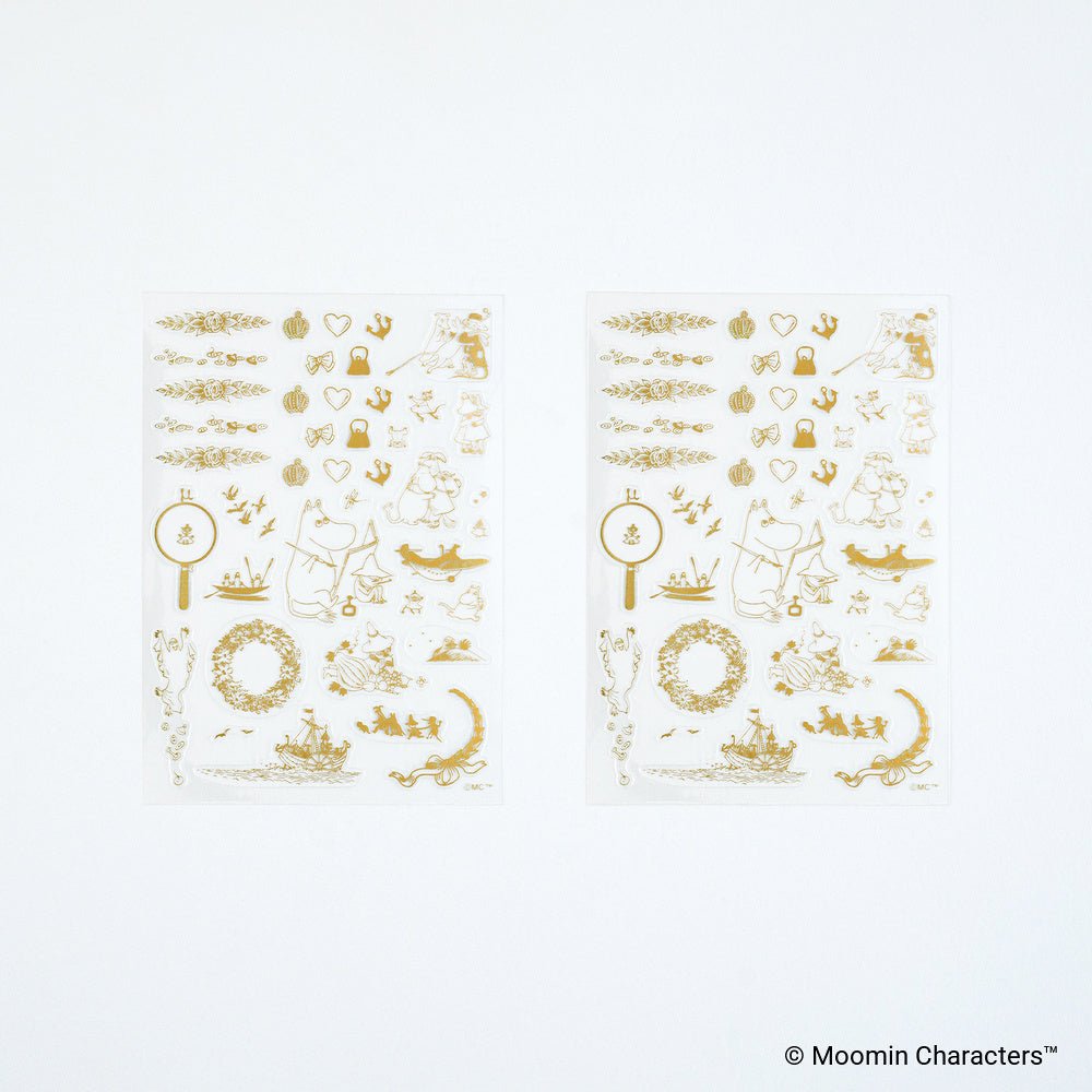 Two sheets of gold foil stickers featuring Moomin Characters designs, displayed on a clean white background.