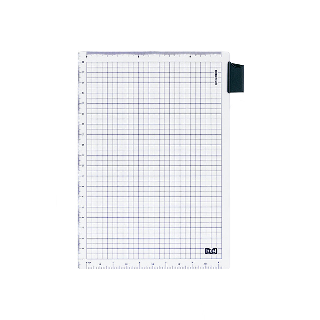 A clear A5-sized pencil board for Hobonichi Techo HON with dark blue grid pattern, ruler measurements, and bookmark tab against white background