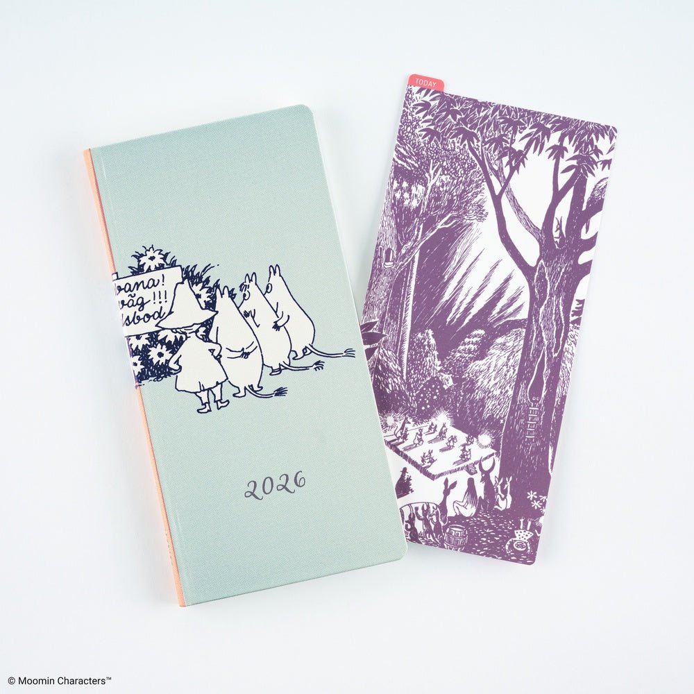 A mint green 2026 Moomin Techo Weeks notebook with black line art illustrations of characters, shown next to a matching purple pencil board featuring a forest scene, on a clean white background.