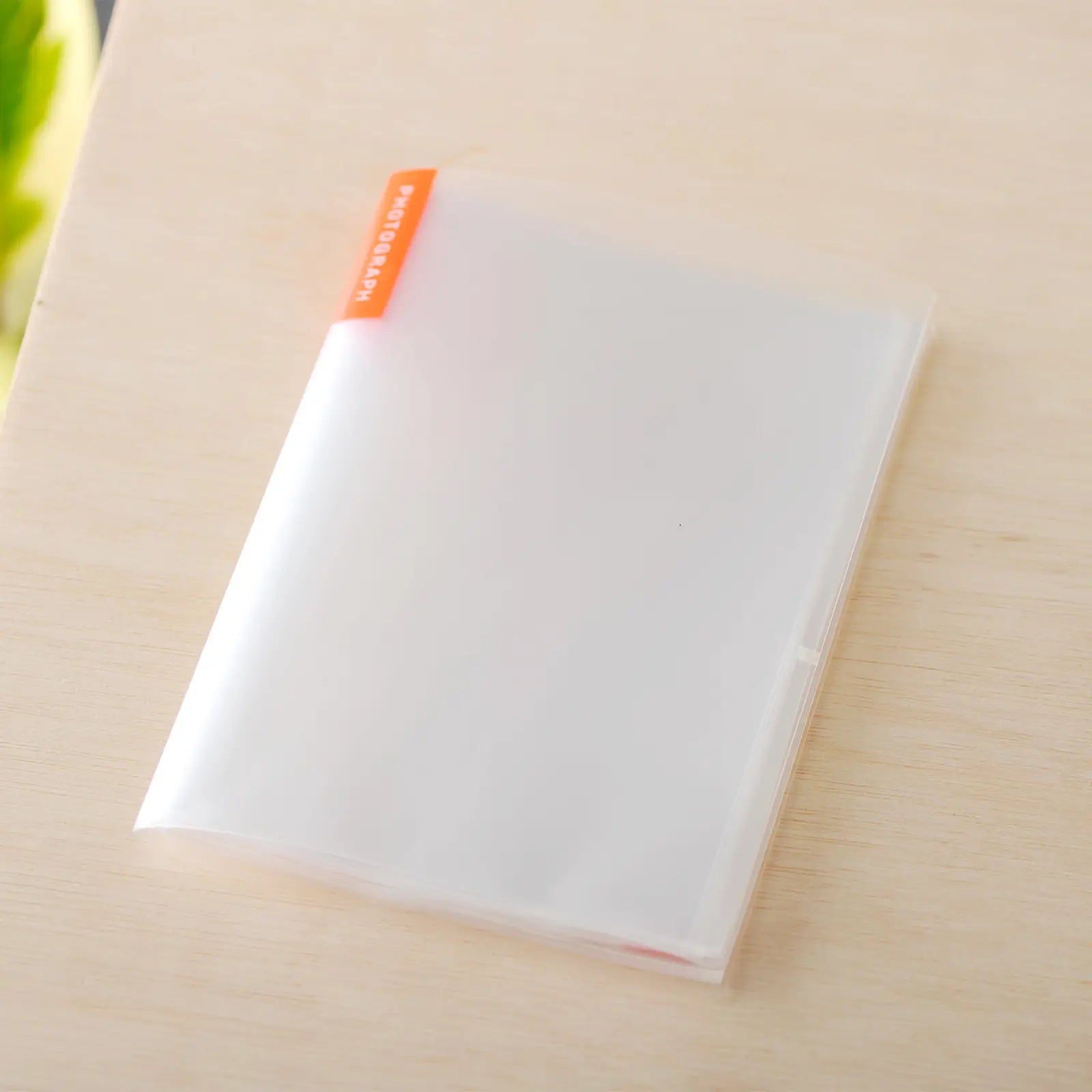 Clear photo album for A6 Hobonichi planner on wooden surface