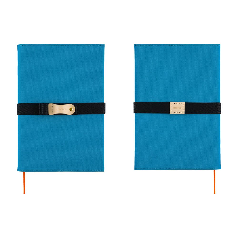 The front and back of a blue Hobonichi Techo cover shown side by side on a white background, each wrapped with a black elastic band and a natural leather pen loop.