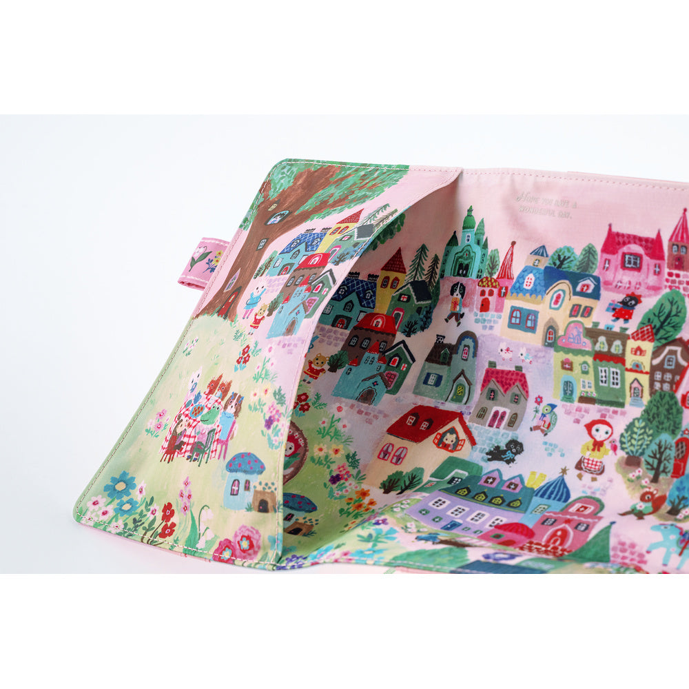An outside pocket of a planner cover on a white background, printed with a whimsical multicolor village scene featuring houses, trees, flowers, and small characters.