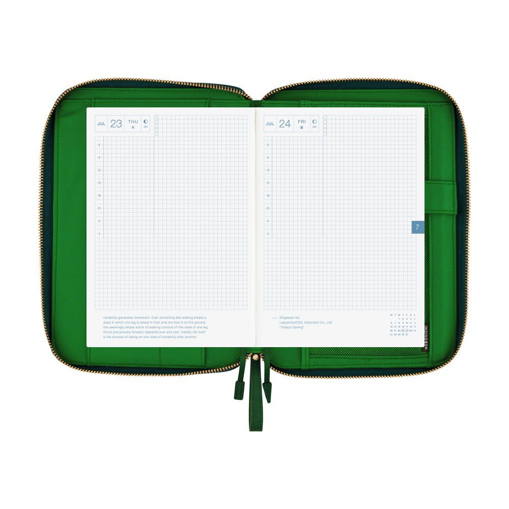 An open green-colored A5 Hobonichi zippered cover holding a gridded planner, with interior pockets, pen holder, and gold zipper visible on a plain white background.