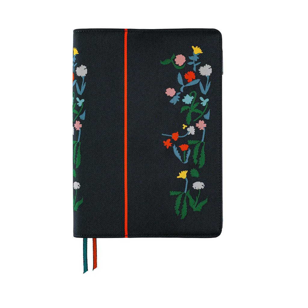Hobonichi Techo navy planner cover with colorful embroidered flowers on the cover, a vertical red stripe, and ribbon bookmarks in blue and red.