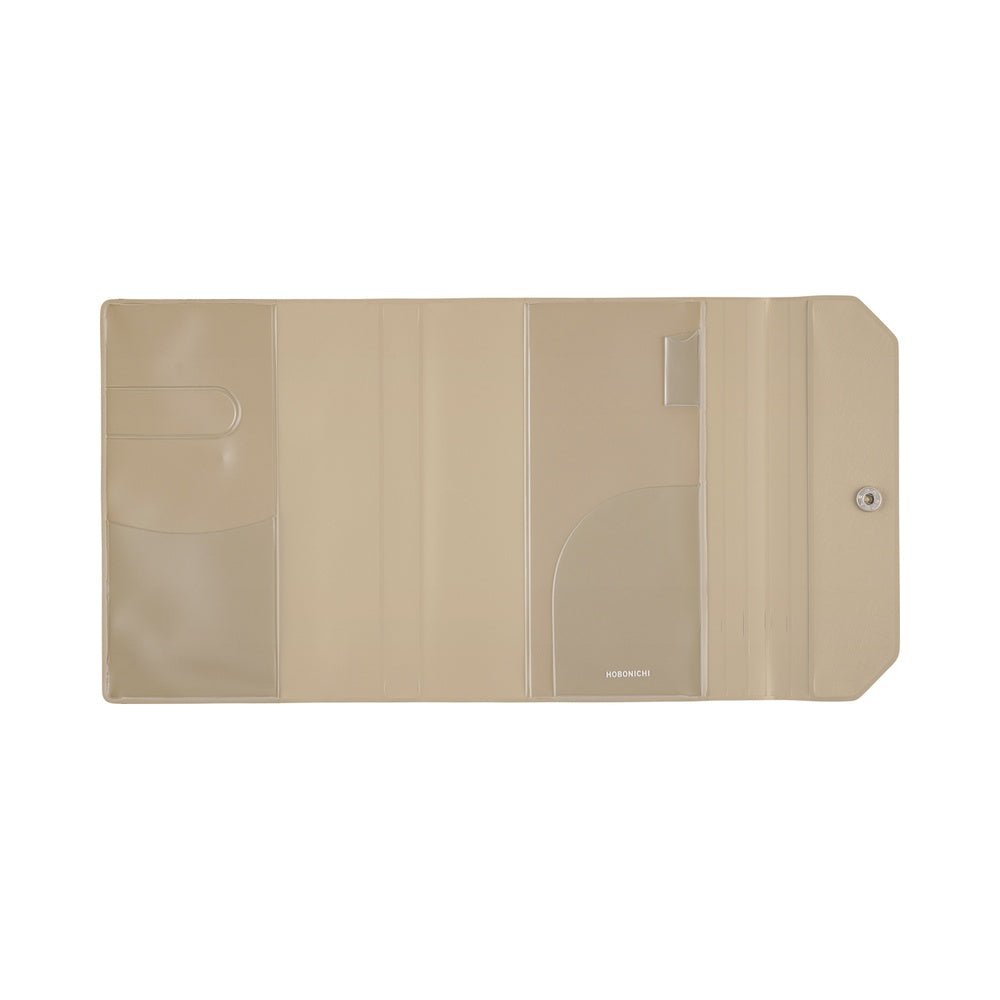 A beige plastic notebook cover with multiple interior pockets and a snap closure, shown open against a plain white background.