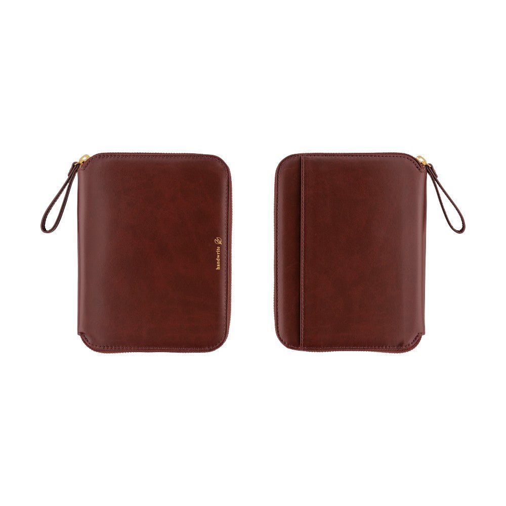 Two red-brown leather zip-around notebook cases with wrist loops, shown side by side on a plain white background. One pouch has a small gold logo on the front, and both have gold zipper pulls.