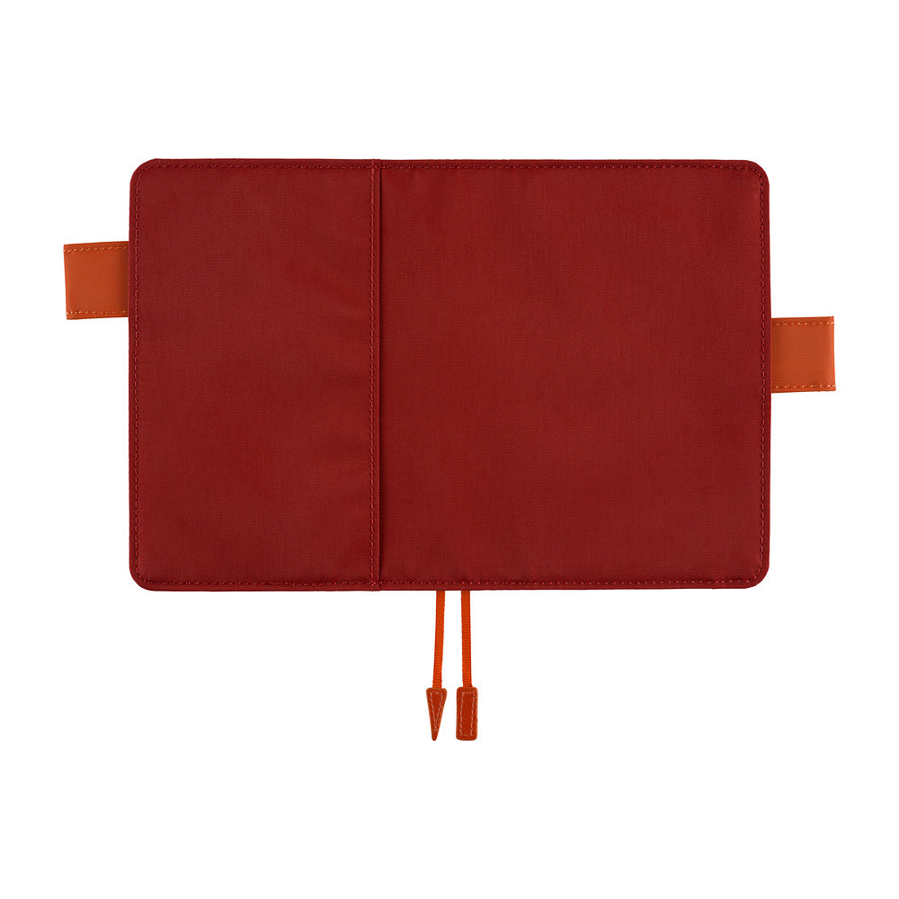 A red notebook cover or planner sleeve shown open flat against a white background, with orange-brown tab loops on the sides and a matching orange-brown drawstring at the bottom.