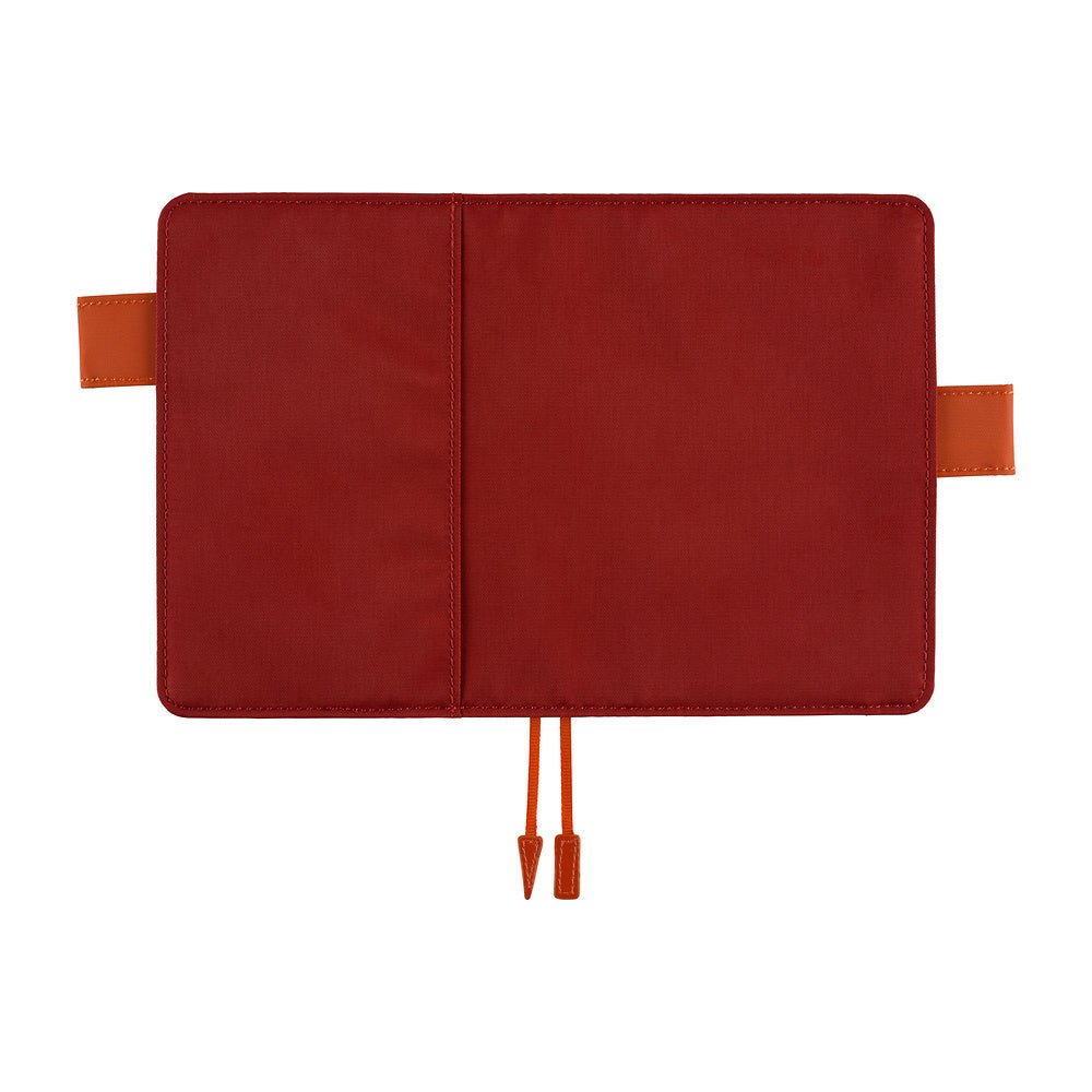 A red notebook cover shown open flat against a white background, with orange-brown pen loops on the sides and matching orange-brown bookmarks at the bottom.