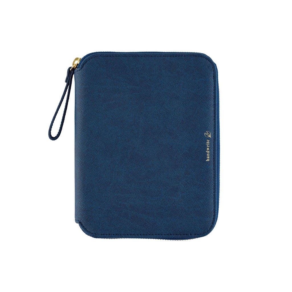 An A6 navy blue zippered notebook pouch with a strap and gold zipper pull, featuring a small gold logo on the right side, shown against a plain white background.