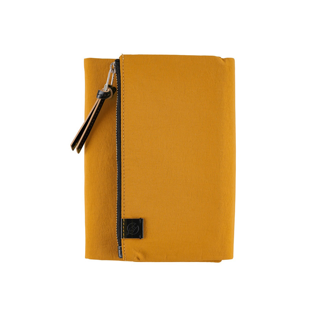 A mustard yellow zippered pouch or sleeve with a black zipper, black leather tassel, and a small black square logo patch on the front, shown against a plain white background.