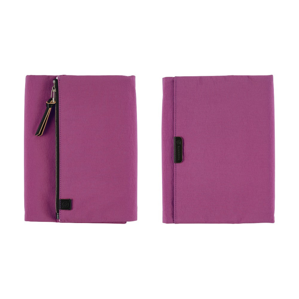 Front and back purple Hobonichi Tragen tri-fold covers with a vertical zippered pouch and black zipper pull shown side by side on a plain white background.