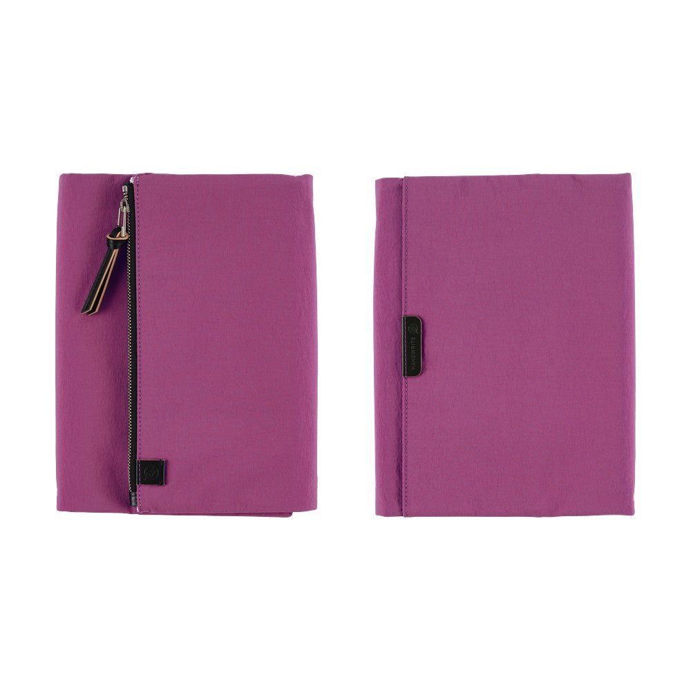 Front and back purple Hobonichi Tragen tri-fold covers with a vertical zippered pouch and black zipper pull shown side by side on a plain white background.