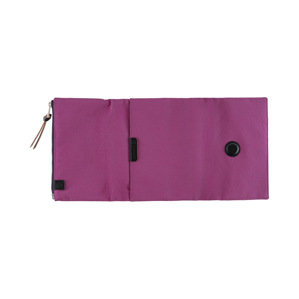 A purple zippered pouch with a magnetic snap closure and a small black tag, shown flat against a white background.