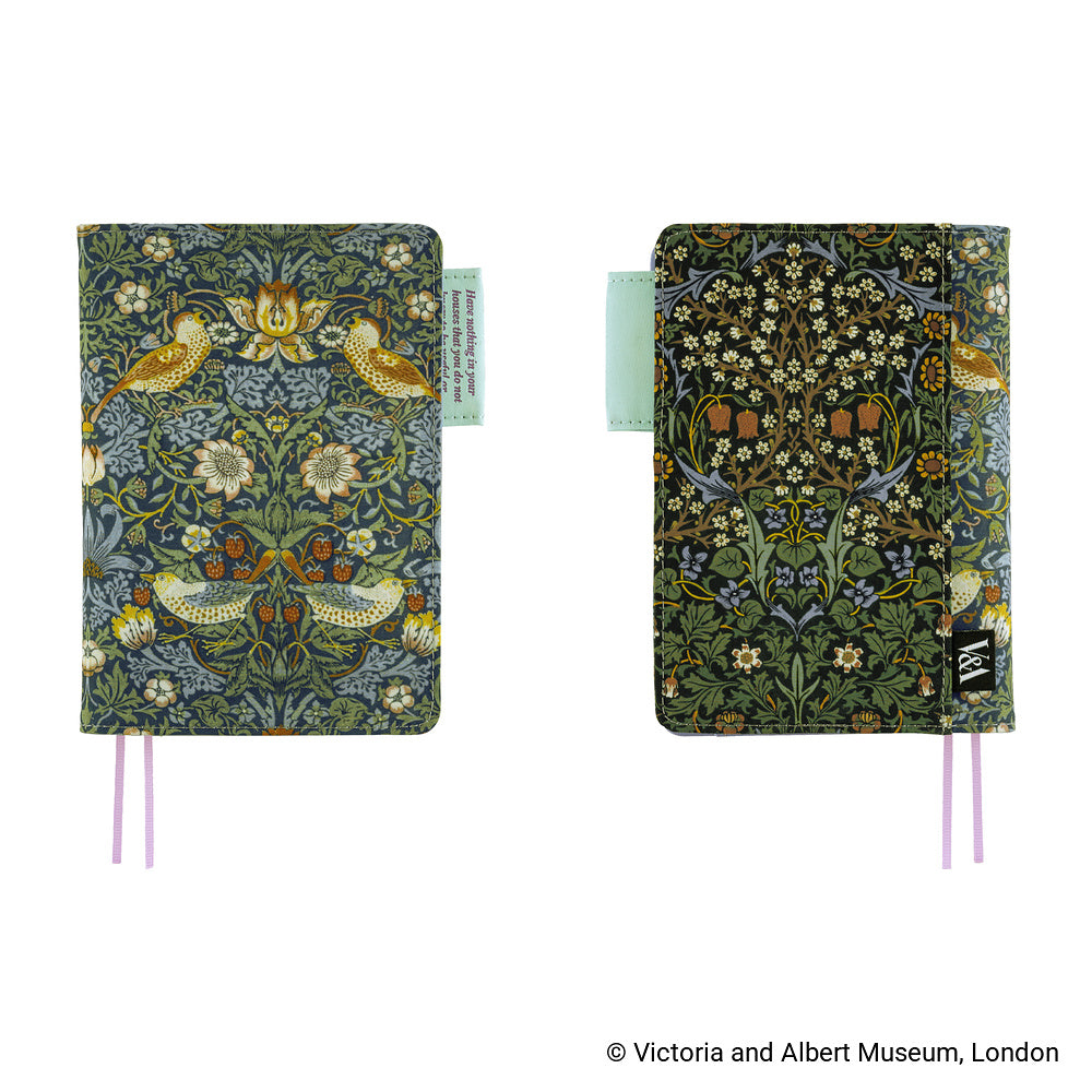 Two William Morris 'The Witch-Craft Garden' pocket notebooks shown side-by-side against a white background, featuring a detailed botanical and bird pattern in muted green, blue, yellow, and white, with pink ribbon bookmarks.