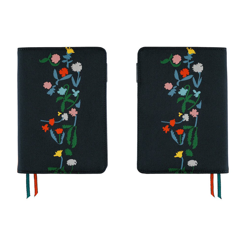 Two views of a navy blue notebook cover with colorful embroidered wildflowers, shown side by side on a white background.