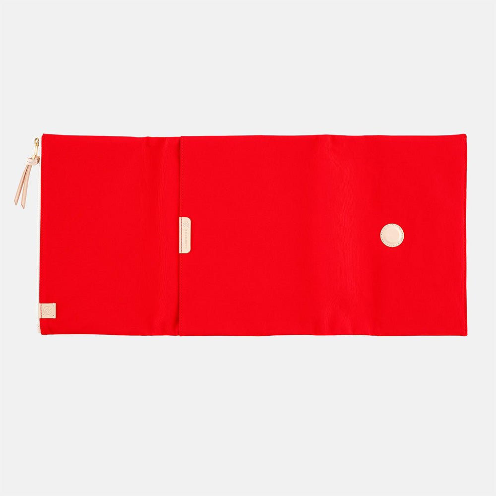 Red fabric Tragen zippered cover for Hobonichi Techo Cousin A5 planner on white background