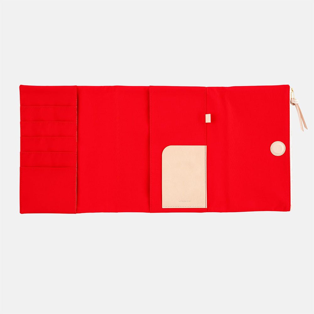Red fabric Tragen zippered cover for Hobonichi Techo Cousin A5 planner on white background