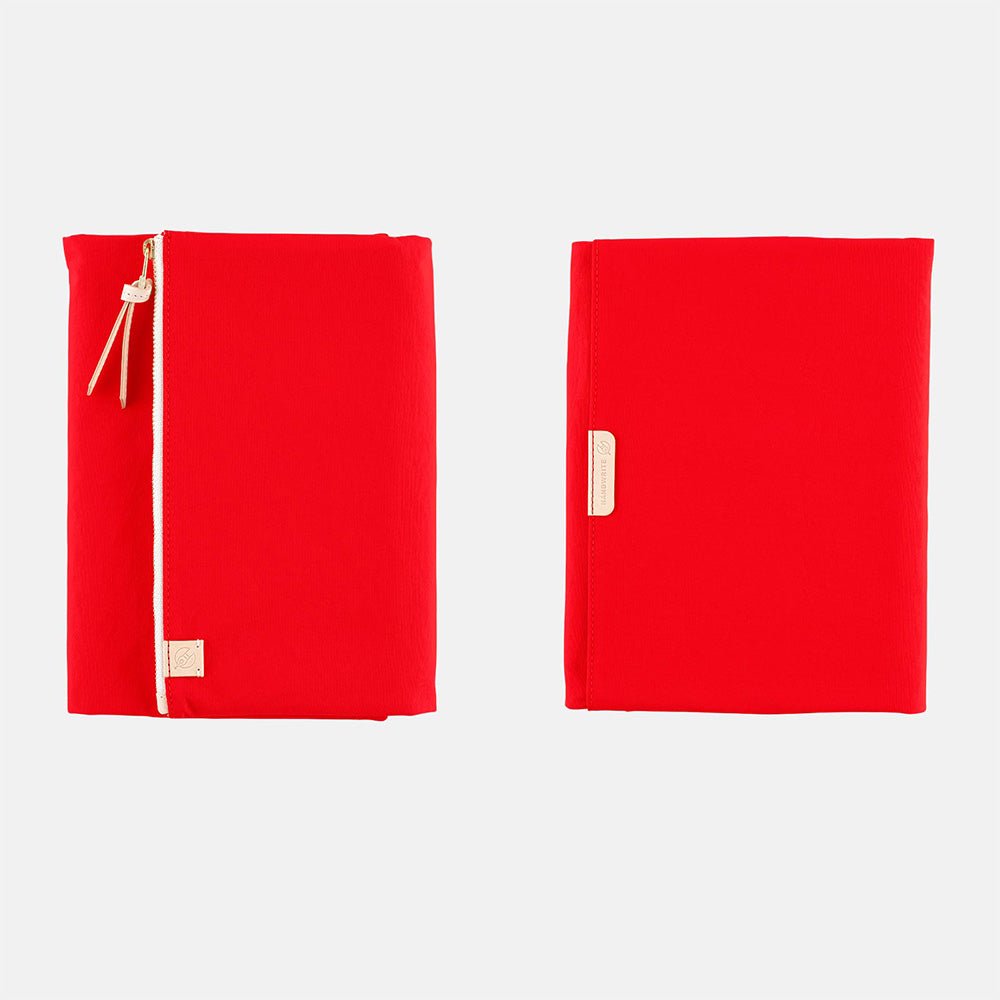 Red fabric Tragen zippered cover for Hobonichi Techo Cousin A5 planner on white background
