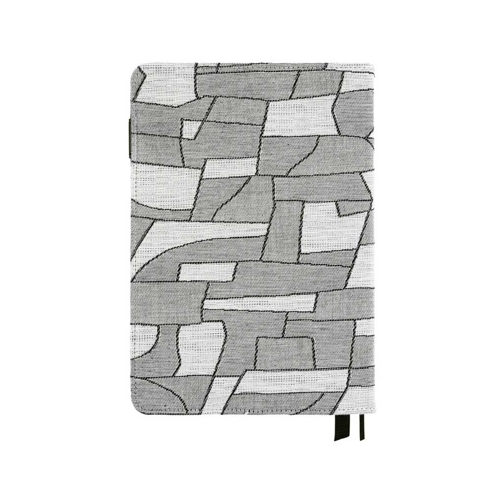 Back of geometric black and white design on fabric cover for Hobonichi Techo Cousin A5 planner on white background