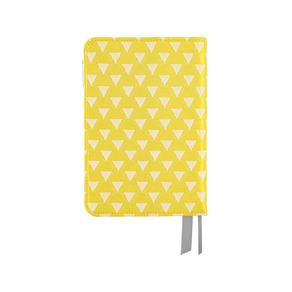 Back of yellow fabric notebook cover with white triangle pattern for Hobonichi Techo A6 planner on white background