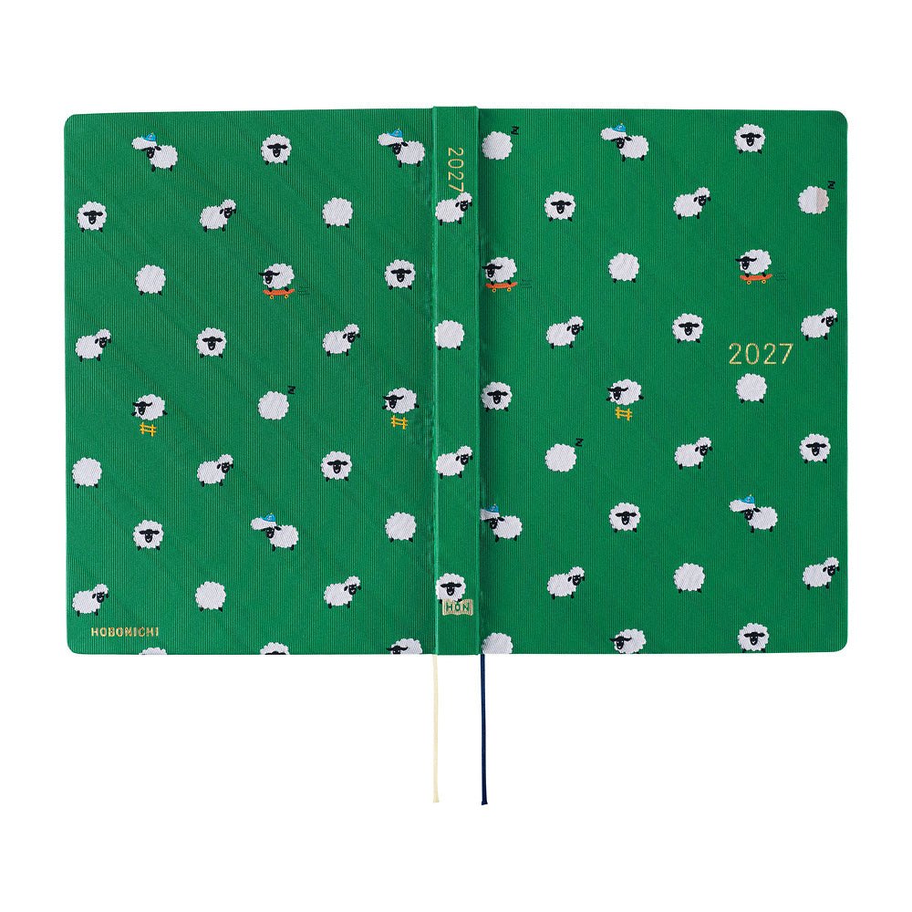A 2027 Hobonichi Techo HON hardcover laid flat to show a bright green design covered with playful white sheep, with two ribbon bookmarks on a white background.