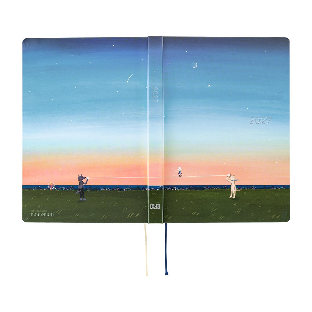 A flat open view of a 2027 Hobonichi Techo HON hardcover planner featuring Hiroko Kubota’s illustration of a cat and wolf using a string telephone across a grassy meadow at sunset, with a mouse riding a unicycle along the line beneath a starry sky and crescent moon.