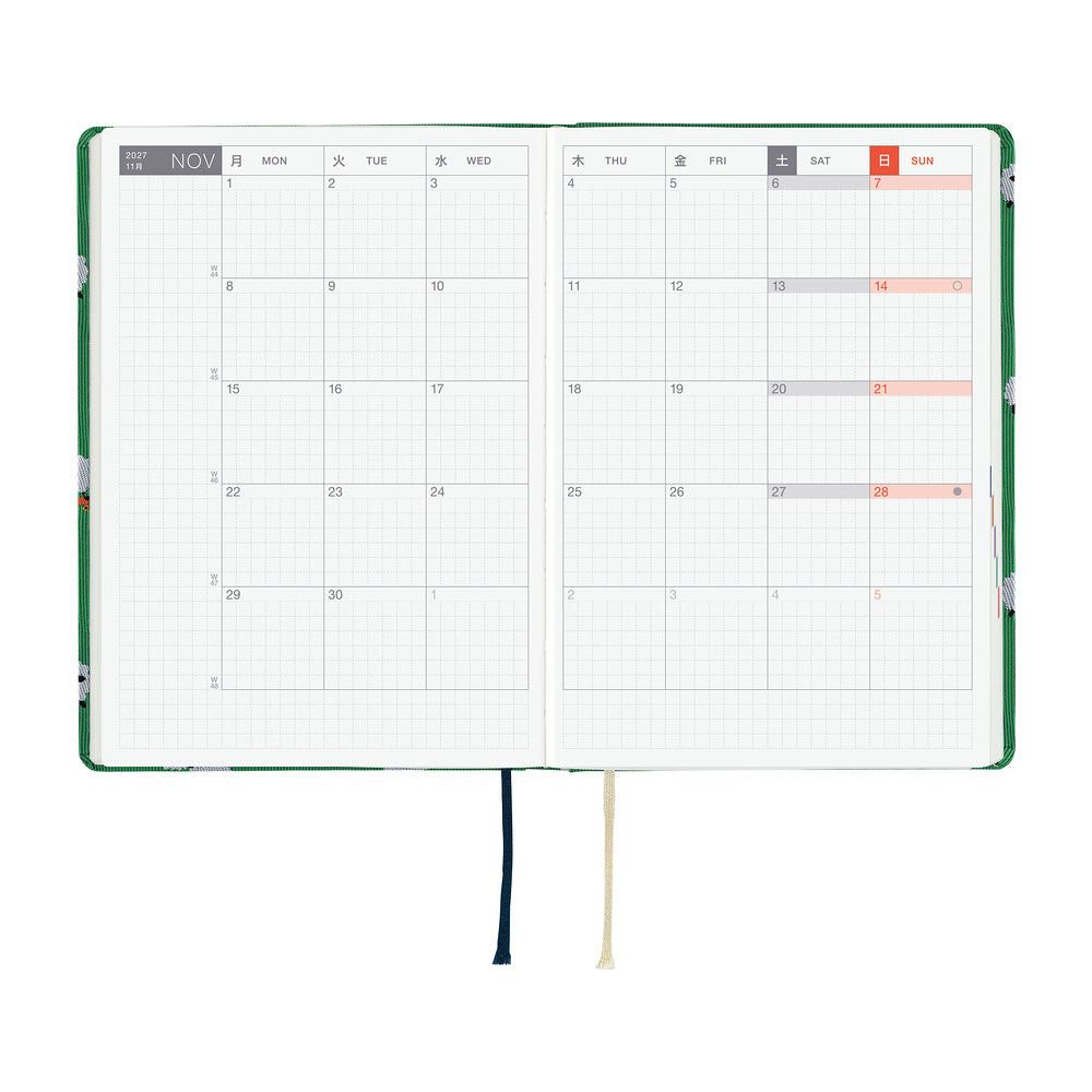 A 2027 Hobonichi HON covered in Bow & Tie fabric woven with a sheep design on a green background