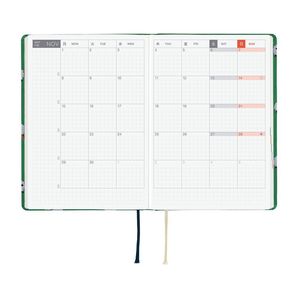 A 2027 Hobonichi HON covered in Bow & Tie fabric woven with a sheep design on a green background