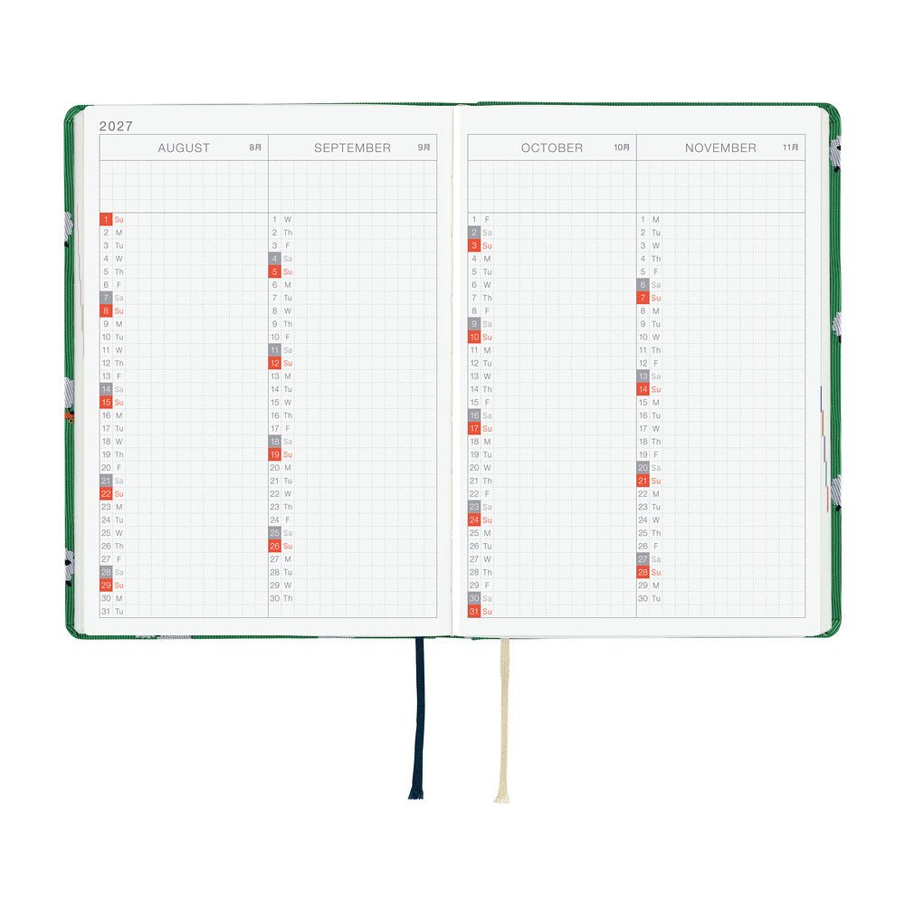 A 2027 Hobonichi HON covered in Bow & Tie fabric woven with a sheep design on a green background