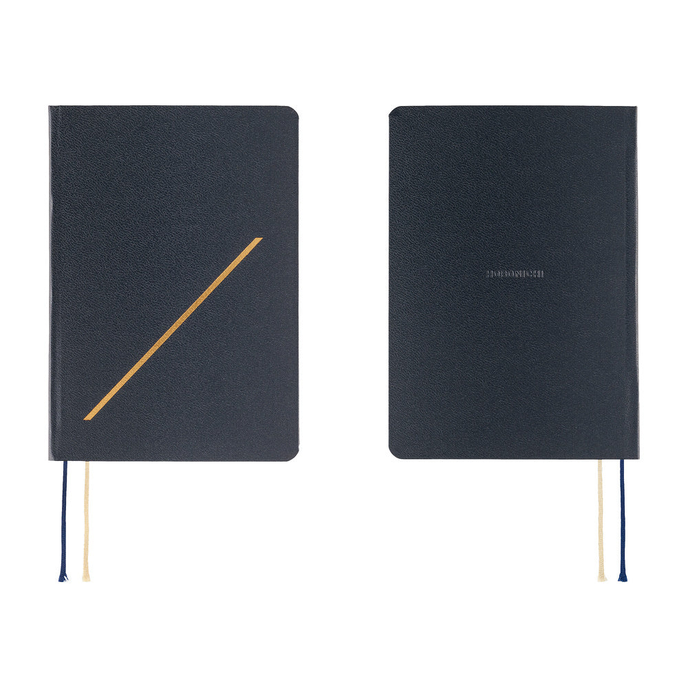 Two dark navy blue hardcover notebooks shown side by side on a white background. The left notebook features a gold diagonal line on the front cover and two ribbon bookmarks in navy and cream.