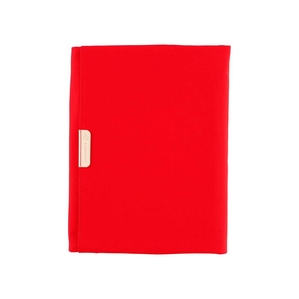 Red fabric Tragen zippered cover for Hobonichi Techo Cousin A5 planner on white background
