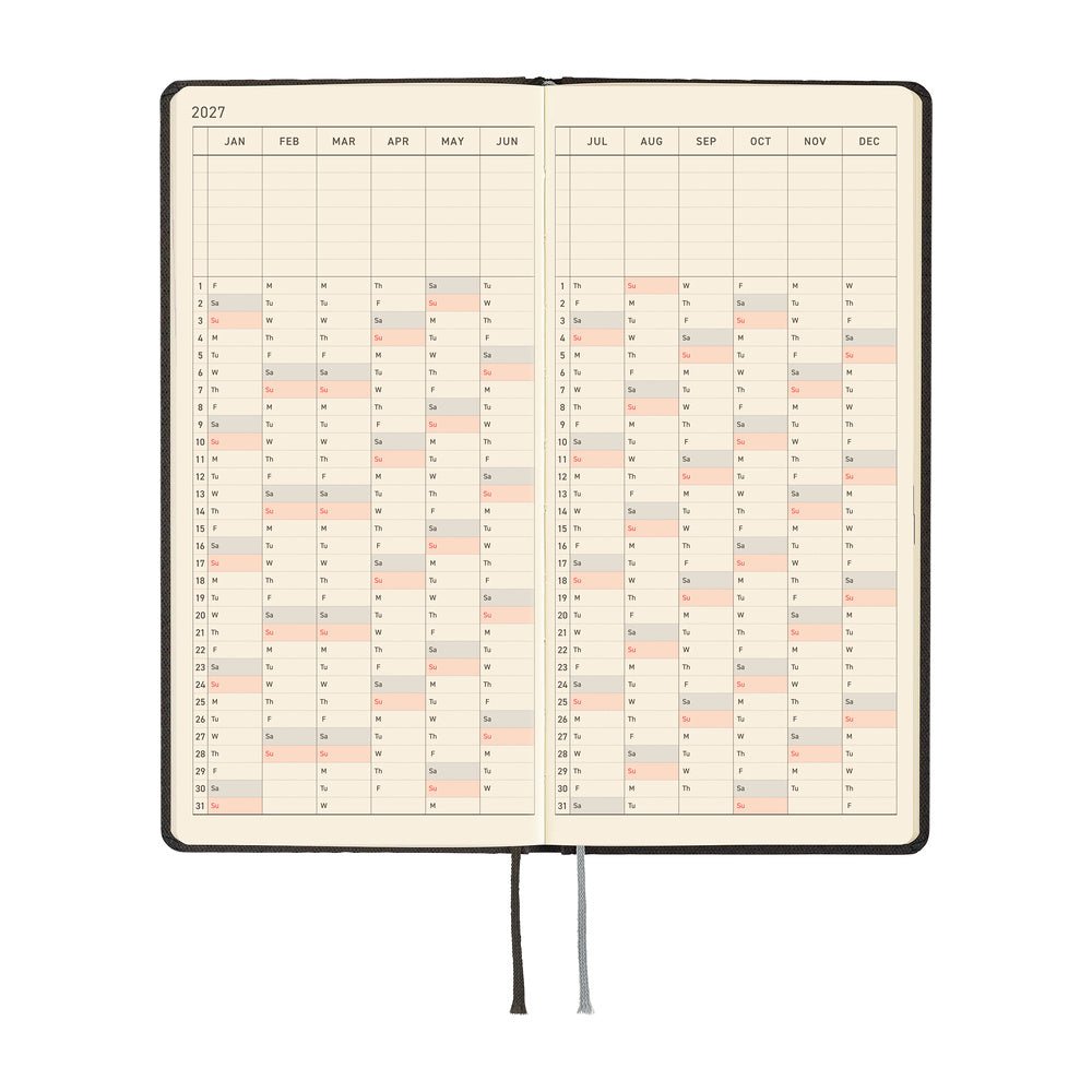 An open 2027 planner showing a yearly spread with cream colored pages.