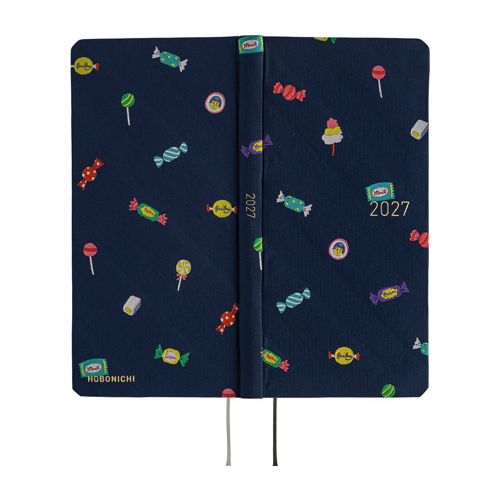 The exterior of a 2027 planner featuring an array of colorful candies woven into a dark navy blue necktie fabric.