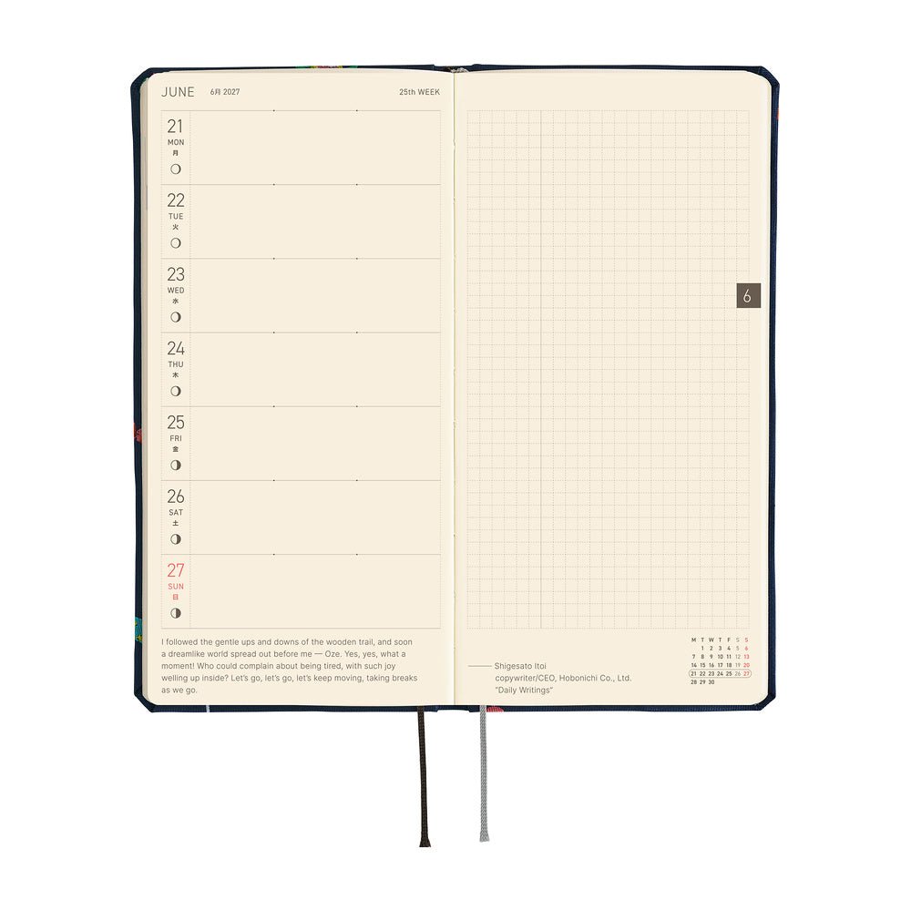An open planner showing a weekly spread with cream-colored pages. The weekly calendar is on the left, while the right page shows a grid page.