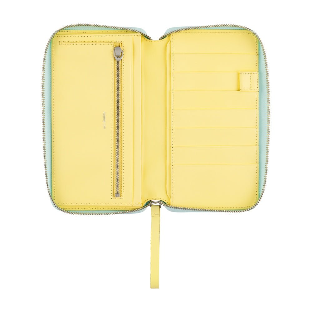 A zippered cover for the Hobonichi Techo Weeks with a yellow interior with a zippered compartment and card slots.