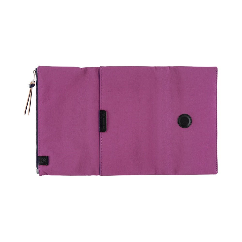 A Hobonichi Weeks Tragen cover in the color Purple open flat on white background.