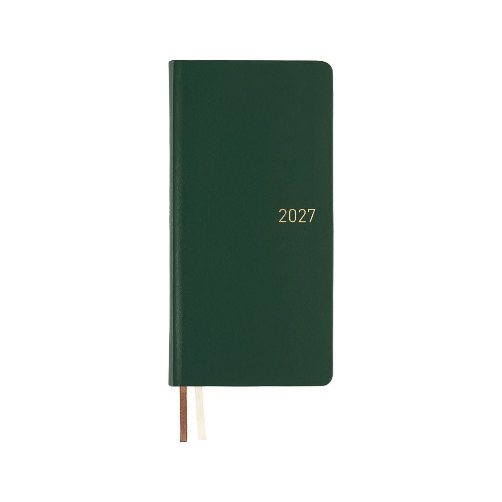 A dark green leather covered planner with the year '2027' printed in gold on the front cover, shown closed on a plain white background with two ribbon bookmarks visible.